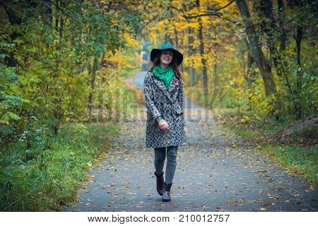 Pretty Romantic Girl In Autumn Clothes Walks In A Park. The Mood Of Autumn, Leaf Fall.