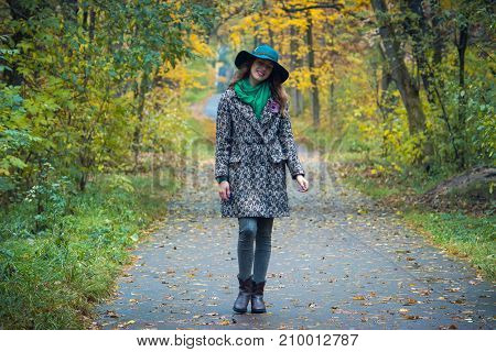 Pretty Romantic Girl In Autumn Clothes Walks In A Park. The Mood Of Autumn, Leaf Fall.