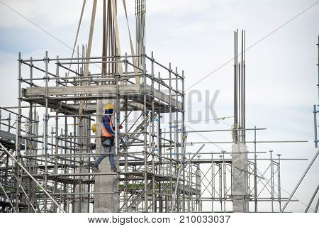 Working at height equipment. Fall arrestor device for worker with hooks for safety body harness on selective focus. Worker as a background.