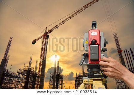 Modern surveyor equipment theodolite or tacheometer used in surveying and building construction for precise measurement. Total station outdoor at construction site. Copy space