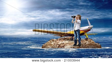 Barn med flygplan på ön i havet.