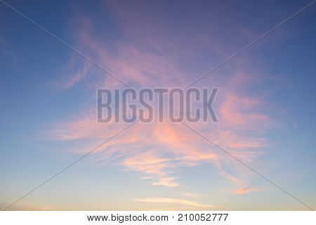 Evening sunlight on coast pink clouds blue sky reflection on water. Beach in summer. Seaside natural environment. Shore in Kesselaid small island in Estonia. Nature Reserve in North Europe