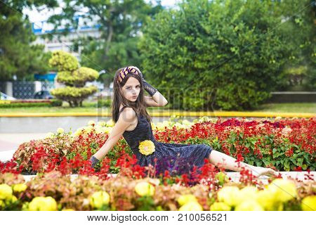 Beautiful young girl in a flower bed.