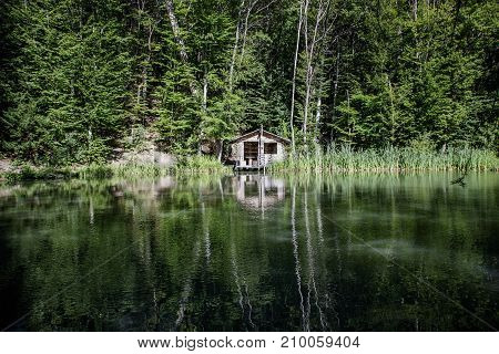 Old Wooden House By The Lake In The Forest