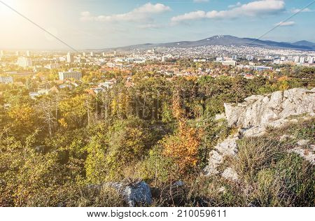 Nitra city under Zobor hill in autumn time. Slovak republic. Urban scene. Seasonal scene. Travel destination. Yellow sun rays.