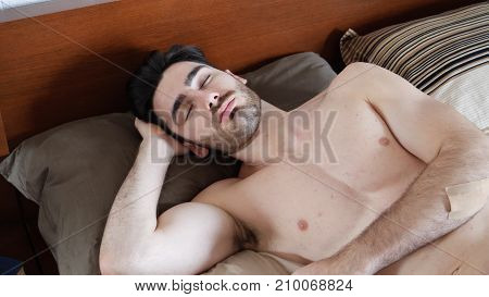 Young Handsome Shirtless Man Sleeping, Lying in Bed in the Morning