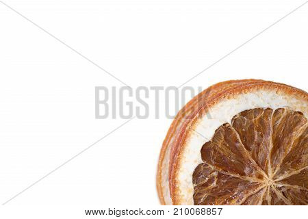 Stack of dried orange slices placed in corner on white background