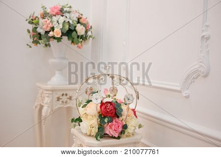 Artificial flowers. Vase with a flower arrangement in an expensive interior.