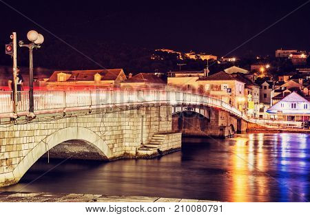 Bridge from Trogir to Ciovo island Croatia. Night scene. Travel destination. Red photo filter.