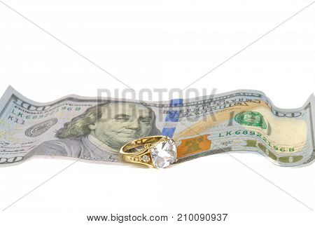 Ring on a $100 bill representing the high cost of weddings, isolated on white