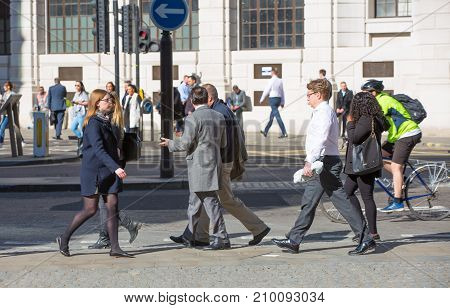 London, UK - March 15, 2017: Walking people in the City of London, Bank street.
