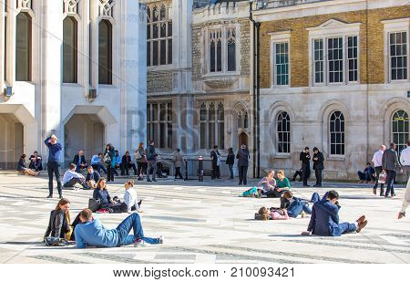 People having a rest during the lunch time in the City of London.