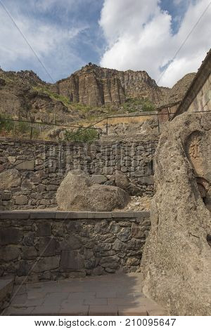 A cross carved in a rock the Geghard monastery in Armenia