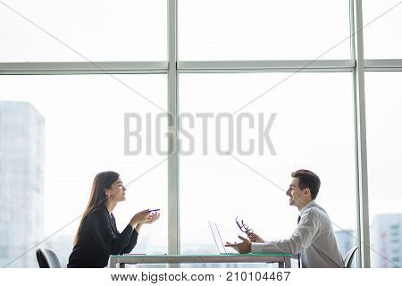 Businessman And Businesswoman Meeting In Modern Office Face To Face Discuss Plans