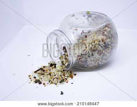 Spilled coarce sea salt with different spices