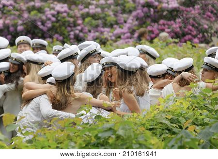 Stockholm Sweden - Jun 13 2017: Happy Teenagers Wearing Graduation Caps Hugging Each Other After Gra