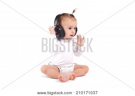 Pretty Cute Little Girl In White Pijamas With Headphones On Head