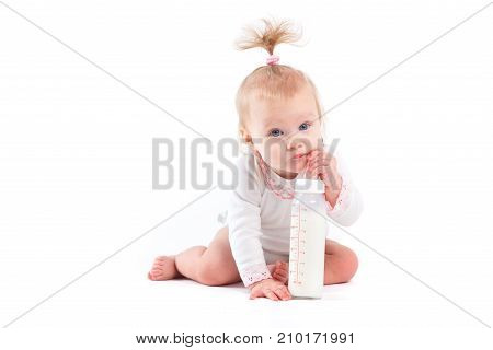 Cute Cheerful Little Girl In White Dress And With Milk Bottle