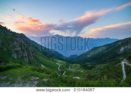 Mountain Road Leading To High Mountain Pass On The Italian Alps.. Expasive View At Sunset, Colorful