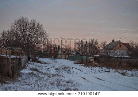 Beautiful morning and winter bright sunrise in January. Suburb and field covered snow