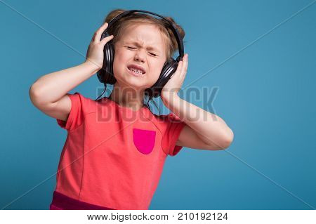 Attractive Little Cute Girl In Pink Dress And Headphones