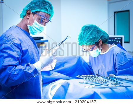 Team surgeon at work in operating room.