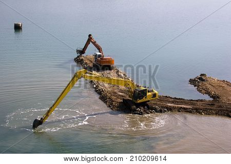 Two backhoes are deepen the seabed between islands Ugljan and Pasman in Croatia