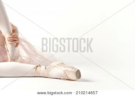 The ballerina's feet in pointes on a light background, ballet, art.
