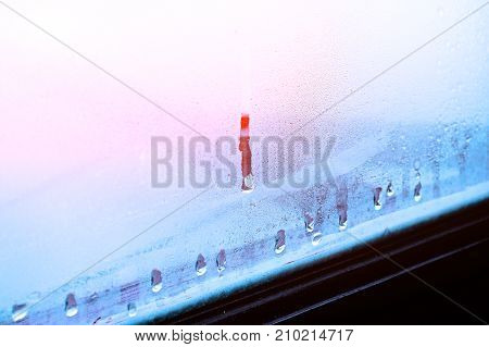 High humidity, condensing large drops of condensed water flow down the glass. Texture of water on a glass background