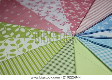 Multicolored cuts of fabric against the background of boards