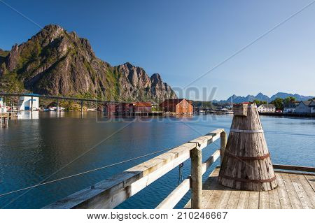 Henningsvaer Norway - August 19 2017: Picturesque fishing port in Henningsvaer on Lofoten islands Norway with typical red wooden buildings and small fishing boats