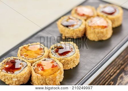Delicious rolls unagi furai. Appetizing set of japanese sushi on plate. Asian traitional food.