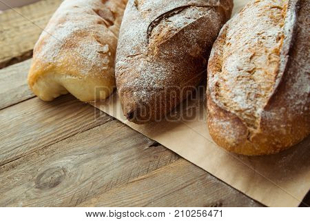 Top view of wholegrain bread on a wooden table. Organic homemade bread for breakfast.