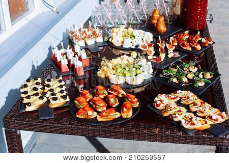 Catering Banquet Table With Different Food Snacks And Appetizers