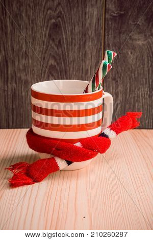 Christmas decorated cup on white wooden background. Cozy magical xmas atmosphere. Preparing for winter holidays concept