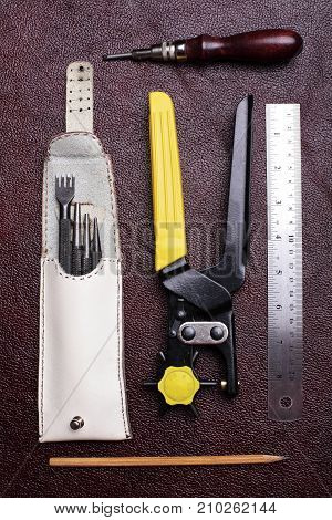 Leather Craft Tools On A Bordo Leather Background