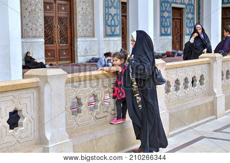 Fars Province Shiraz Iran - 19 april 2017: Shah Cheragh Shrine Mother walks with her little daughter in the courtyard of the mosque.