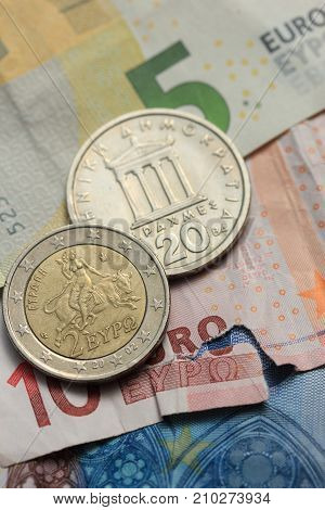 Vintage greek Drachma coins on european banknotes