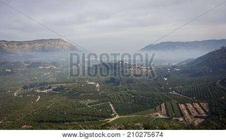 mist in the Valldigna valley Valencia Spain with the town of Simat in the distance