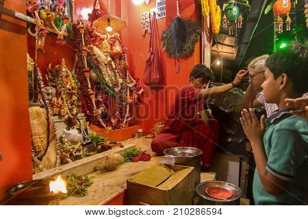 KOLKATA WEST BENGAL INDIA - 13 MAY 2017: Hindu priest worshipping Lord Hanuman known as Hanuman ji in India. Hindu religious persons are praying in front of the idol in the holy temple.