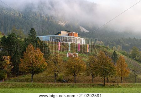 Bad Bleberg Austria - October 10 2017: View of the Vivea Gesundheits hotel in the early foggy morning. Yellow autumn leaves of trees are especially adorned with a mountain landscape.