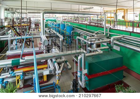 Industrial boiler room. Complex system of pipelines, pumps and valves.