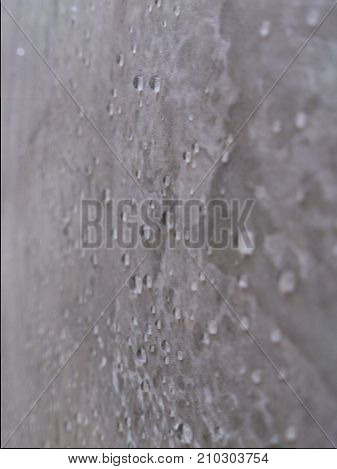 The wall is polished and beautiful in front of the wall in the background.