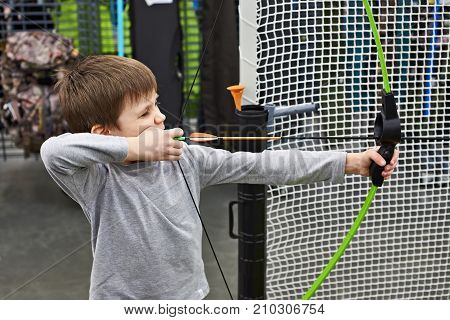 Little Boy Shoots By Bow In Children's Shooting Range