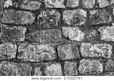 Wall made of stones of different shapes and sizes. Background