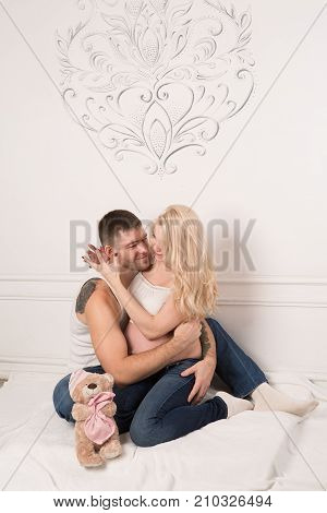 Beautiful pregnant couple in love on the background. Hands of husband on the tummy of his pregnant wife. Young man tenderly stroked pregnant belly of his wife. Husband kissing pregnant belly.