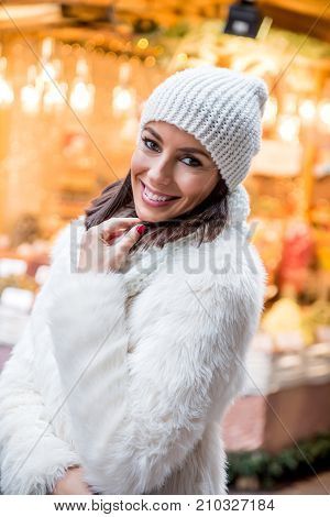 Portrait of a beautiful young woman on the christmas market.