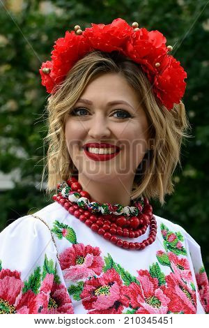 LVIV UKRAINE - 24 AUGUST 2017: Beautiful smiling Ukrainian woman in a traditional embroidered shirt with flowers on her head during the celebration of the holiday of the independence
