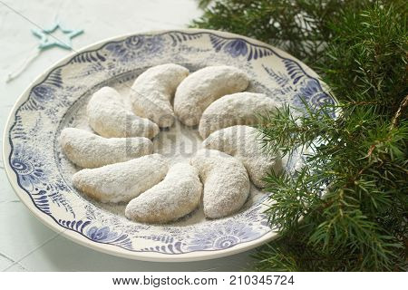 Vanilkipferl - vanilla crescents traditional Christmas cookies in Germany Austria Czech Republic. Homemade cookies in Christmas or New Year's decor. Selective focus.