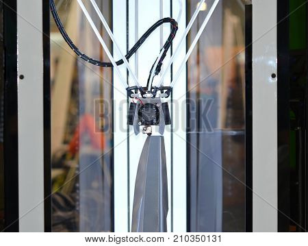 3-Axis 3d printer building gray abstractobject liquid molten plastic close-up. The concept of modern additive technology. The 4ht industrial revolution.